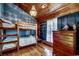 Charming bedroom featuring wood walls, hardwood floors, with a bunk bed set and decorative accents at 181 Halfway Rd., Nichols, SC 29581