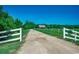 Gated entrance to a charming ranch home with a long driveway and lush landscaping at 181 Halfway Rd., Nichols, SC 29581