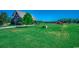 Exterior view of a home with a metal roof and lush green lawn, fenced in pasture and mature trees at 181 Halfway Rd., Nichols, SC 29581