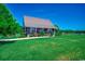 Charming home with a metal roof, covered front porch, and well-manicured landscaping and front yard at 181 Halfway Rd., Nichols, SC 29581