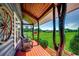 Cozy front porch featuring rocking chairs, a swing, and views of the lush lawn at 181 Halfway Rd., Nichols, SC 29581
