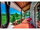 Inviting front porch with rocking chair and swing with views of the lush green front yard and trees at 181 Halfway Rd., Nichols, SC 29581