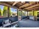 Screened porch with wood ceiling, outdoor furniture, and a view of the surrounding trees and landscaping at 181 Halfway Rd., Nichols, SC 29581