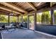 Screened-in porch featuring wood ceiling, outdoor furniture, and view of the surrounding trees at 181 Halfway Rd., Nichols, SC 29581