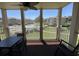 A shaded balcony with a table and chairs, overlooking the community pool and the well-maintained landscaping at 1900 Duffy St. # L-5, North Myrtle Beach, SC 29582