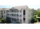A well-maintained condo building with multiple balconies and classic architectural details, set in a beautiful landscape at 1900 Duffy St. # L-5, North Myrtle Beach, SC 29582