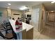 A modern kitchen with stainless steel appliances, a long bar counter with chairs, and light wood-look flooring at 1900 Duffy St. # L-5, North Myrtle Beach, SC 29582