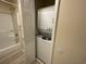 Convenient in-unit laundry featuring a stacked washer and dryer, with additional shelving at 1900 Duffy St. # L-5, North Myrtle Beach, SC 29582