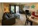 Comfortable living room with a sofa, chair, beach decor, and a sliding glass door to a balcony at 1900 Duffy St. # L-5, North Myrtle Beach, SC 29582