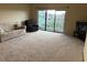Cozy living room featuring plush carpet, balcony access and comfortable furniture at 1930 Bent Grass Dr. # 39H, Surfside Beach, SC 29575