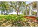 Expansive backyard featuring lush green grass, mature trees, and a glimpse of the tranquil waterfront at 21 Whitehall Ave., Georgetown, SC 29440