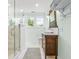Bright bathroom featuring a glass enclosed shower, marble floors, and wooden vanity at 21 Whitehall Ave., Georgetown, SC 29440