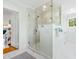 Bright bathroom with walk-in shower featuring marble tile, a glass door, and vanity at 21 Whitehall Ave., Georgetown, SC 29440