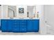 Stylish bathroom showcasing a double sink vanity with vibrant blue cabinetry and gold hardware at 21 Whitehall Ave., Georgetown, SC 29440