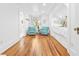 Bright bedroom featuring hardwood floors, two turquoise chairs, and a built-in alcove bed at 21 Whitehall Ave., Georgetown, SC 29440