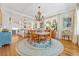 Sunlit dining area with hardwood floors, chandelier, and views to a modern kitchen at 21 Whitehall Ave., Georgetown, SC 29440