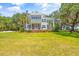 Elegant two-story home with a welcoming front porch surrounded by mature trees and a green lawn at 21 Whitehall Ave., Georgetown, SC 29440