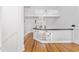 Bright foyer with hardwood floors, white walls, staircase and upper-level landing at 21 Whitehall Ave., Georgetown, SC 29440