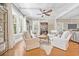 Brightly lit living room featuring hardwood floors, windows, ceiling fan, and seating area at 21 Whitehall Ave., Georgetown, SC 29440