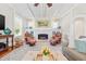 Cozy living room features a brick fireplace, ceiling fan, and comfortable leather seating at 21 Whitehall Ave., Georgetown, SC 29440