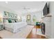 Light main bedroom with fireplace, white carpet, windows, and TV at 21 Whitehall Ave., Georgetown, SC 29440