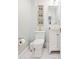 Charming powder room features painted walls, white fixtures, and decorative artwork at 21 Whitehall Ave., Georgetown, SC 29440