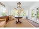 Cozy sitting area with windows, hardwood floors, round table, and a charming rattan chair at 21 Whitehall Ave., Georgetown, SC 29440