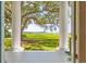 Scenic view from the porch showcasing the lush green lawn with mature tree to the scenic waterway beyond at 21 Whitehall Ave., Georgetown, SC 29440