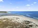 Expansive aerial view showcases the beach with peaceful water and a serene, natural environment on a sunny day at 2408 Hillbourne Loop, North Myrtle Beach, SC 29582