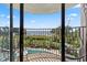 Balcony overlooking the beach with a view of a pool, palm trees, and blue skies at 2500 N Ocean Blvd. # 102, Myrtle Beach, SC 29577