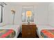 This bedroom has 2 twin beds, simple decor, and a shared nightstand with a lamp at 2500 N Ocean Blvd. # 102, Myrtle Beach, SC 29577