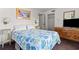 View of a bedroom with a queen size bed, vintage furnishings, and nautical artwork at 2500 N Ocean Blvd. # 102, Myrtle Beach, SC 29577