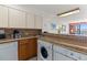Kitchen featuring a sink, dishwasher, washer, dryer, and open access to the living area at 2500 N Ocean Blvd. # 102, Myrtle Beach, SC 29577