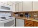 Kitchen with white appliances, including a stove, microwave, dishwasher, and countertop appliances at 2500 N Ocean Blvd. # 102, Myrtle Beach, SC 29577