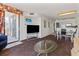 Bright living room with TV, sofa, and glass table, open to dining area and balcony access at 2500 N Ocean Blvd. # 102, Myrtle Beach, SC 29577