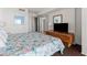 View of a main bedroom featuring bright patterned linens, a TV, and access to a closet at 2500 N Ocean Blvd. # 102, Myrtle Beach, SC 29577