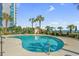 An inviting outdoor pool surrounded by lush tropical landscaping and ocean views at 2500 N Ocean Blvd. # 102, Myrtle Beach, SC 29577