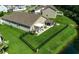 Aerial view of a home featuring a fenced backyard with a covered patio, outdoor kitchen, and pond at 251 Copper Leaf Dr., Myrtle Beach, SC 29588