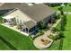 Aerial view showcases an outdoor patio, fire pit, and lush landscaping within the fenced backyard at 251 Copper Leaf Dr., Myrtle Beach, SC 29588