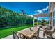 Outdoor dining set on the patio with pergola and scenic view of pond and trees at 251 Copper Leaf Dr., Myrtle Beach, SC 29588