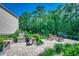 Beautiful backyard with a stone water feature, outdoor lounge chairs, and a fire pit surrounded by lush landscaping at 251 Copper Leaf Dr., Myrtle Beach, SC 29588