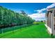 Picturesque backyard featuring a lush lawn, tranquil water view, and a well-maintained fence, creating a private oasis at 251 Copper Leaf Dr., Myrtle Beach, SC 29588