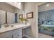 Well-lit bathroom features a vanity with a white countertop and decorative vase, with view into connecting bedroom at 251 Copper Leaf Dr., Myrtle Beach, SC 29588