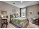 Cozy bedroom featuring a queen bed with a colorful comforter, a desk and chair, and a comfortable sitting area at 251 Copper Leaf Dr., Myrtle Beach, SC 29588