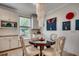 Charming dining area with a round glass table, elegant chandelier, and built-in cabinets for storage and display at 251 Copper Leaf Dr., Myrtle Beach, SC 29588