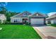 Charming single-story home featuring stone accents, a well-manicured lawn, and an attached two-car garage at 251 Copper Leaf Dr., Myrtle Beach, SC 29588