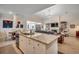 Open-concept kitchen with a large island, granite countertops, stainless steel appliances, and seamless connection to the living area at 251 Copper Leaf Dr., Myrtle Beach, SC 29588
