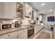 Bright kitchen featuring white cabinets, stainless steel appliances, and granite countertops, perfect for cooking and entertaining at 251 Copper Leaf Dr., Myrtle Beach, SC 29588