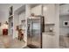 Modern kitchen featuring stainless steel refrigerator, white cabinets, granite countertops, and a built-in desk area at 251 Copper Leaf Dr., Myrtle Beach, SC 29588