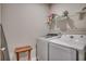 Functional laundry room with front-loading washer and dryer, overhead shelving, and neutral colored walls at 251 Copper Leaf Dr., Myrtle Beach, SC 29588